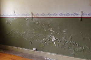 The interior plaster work on the north wall clearly showing damp damage.